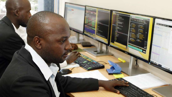 Stockbrokers monitor trade on Uganda Securities Exchange in Kampala, PHOTO | FILE | NMG