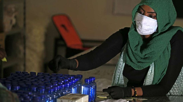 A Sudanese medical laboratory student prepare sterilisers to combat the spread of Covid-19