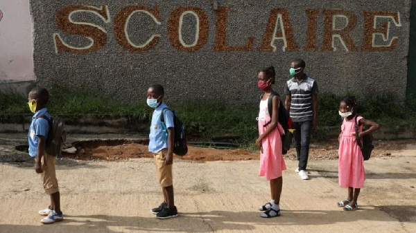 Children queue to wash their hands in a school in Ivory Coast