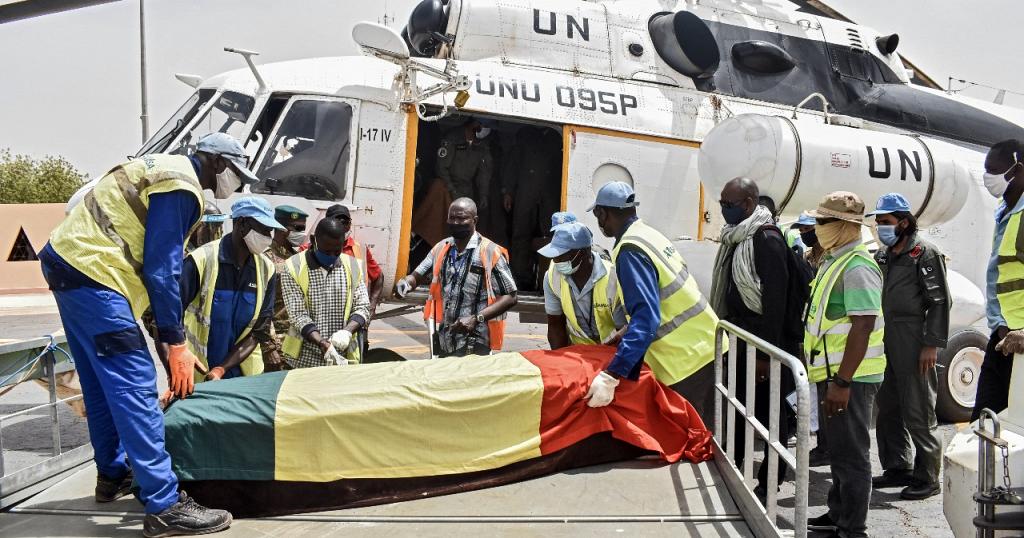 Men carry the coffin of Ould Sidati, president of the Co-ordination of Azawad Movements (CMA) onto a United Nations helicopter ahead of his burial in Timbuktu on April 16, 2021