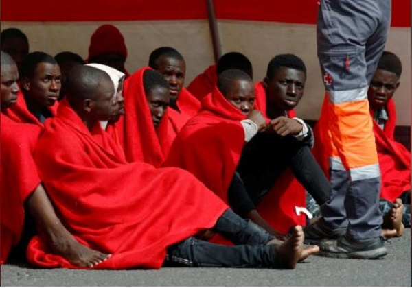 Migrants rescued in the Atlantic Ocean disembark from a Spanish coast