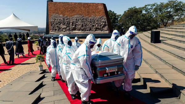 Pallbearers carry the coffin of late Zimbabwe's agriculture minister Perrance Shiri at his funeral