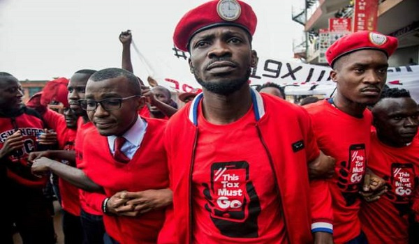 Uganda's opposition presidential candidate, Bobi Wine flanked by others