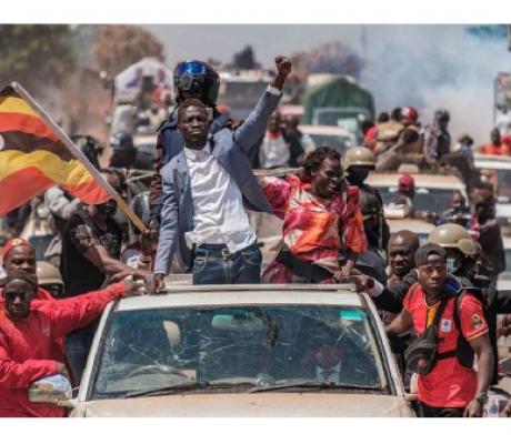 Bobi Wine (centre) greets supporters as he sets off on his campaign trail in Kayunga (AFP)