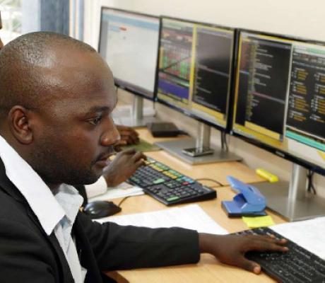 Stockbrokers monitor trade on Uganda Securities Exchange in Kampala, PHOTO | FILE | NMG