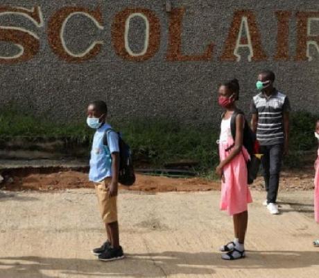 Children queue to wash their hands in a school in Ivory Coast