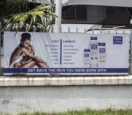 File- A billboard advertises products to restore natural skin colour on Spintex Road in Accra, Ghana, on July 2, 2018