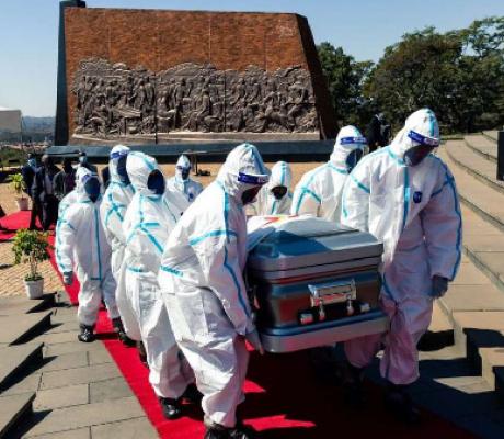 Pallbearers carry the coffin of late Zimbabwe's agriculture minister Perrance Shiri at his funeral