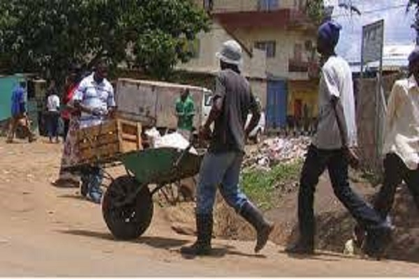 A man pushing a wheelbarrow