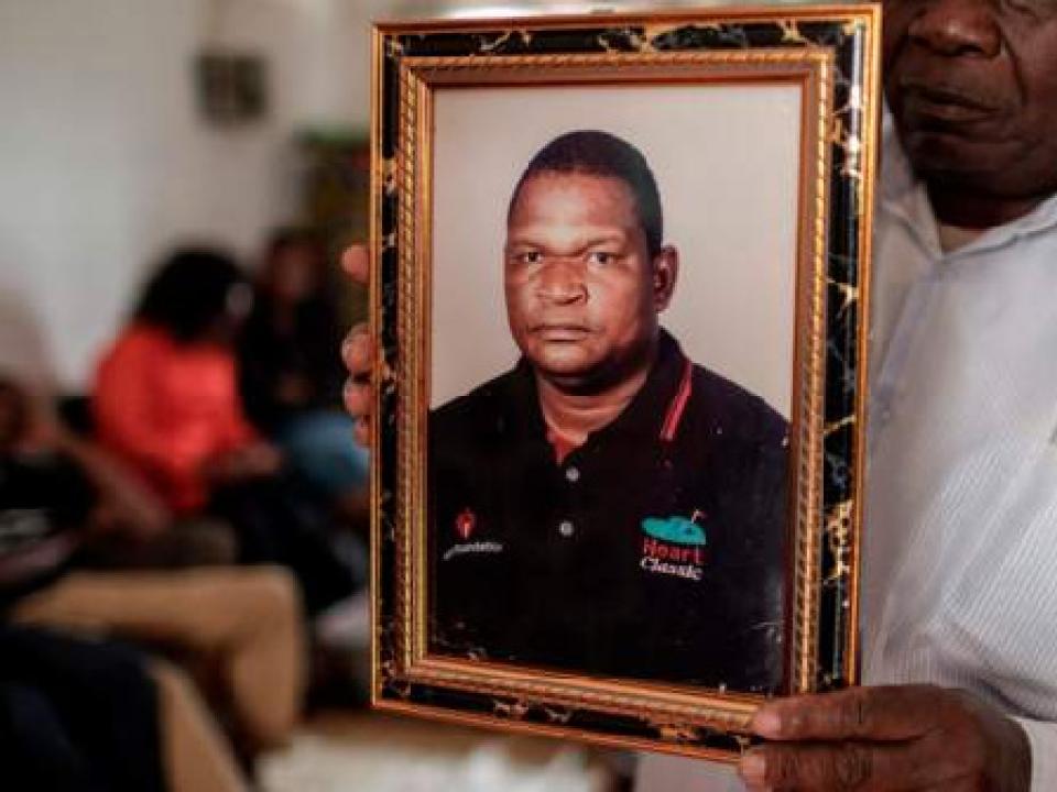 Anastacio Matavele, whose picture is being held by a family member, was killed in October