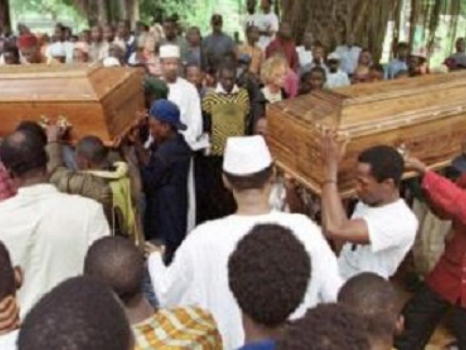 Flag-clad coffins holding the seven bodies headed towards the Festival square for burial