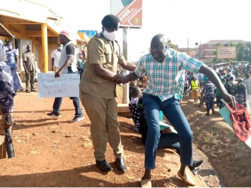 Gulu DPC Emmanuel Mafundo arrests Aruu county MP Samuel Odonga Otto during a protest on June 1, 2020