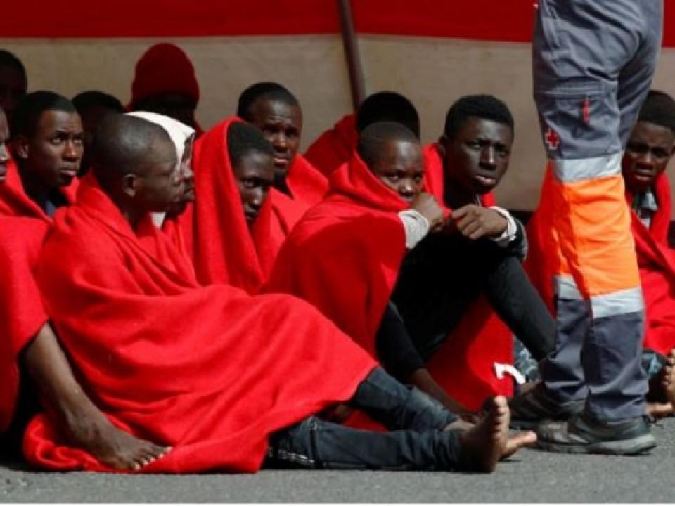 Migrants rescued in the Atlantic Ocean disembark from a Spanish coast