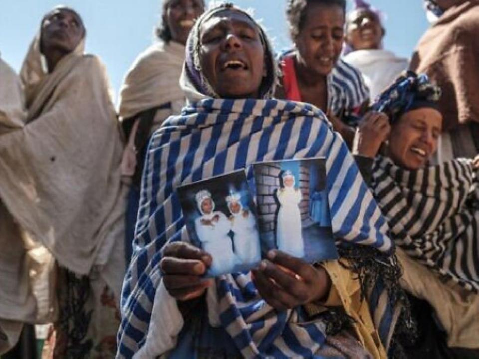 Women mourn the victims of a massacre allegedly perpetrated by Eritrean Soldiers