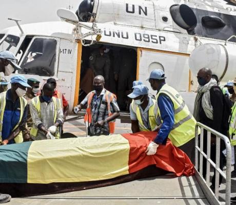 Men carry the coffin of Ould Sidati, president of the Co-ordination of Azawad Movements (CMA) onto a United Nations helicopter ahead of his burial in Timbuktu on April 16, 2021