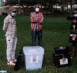 Electoral commission officials wait with ballot boxes at the National theatre in Kampala